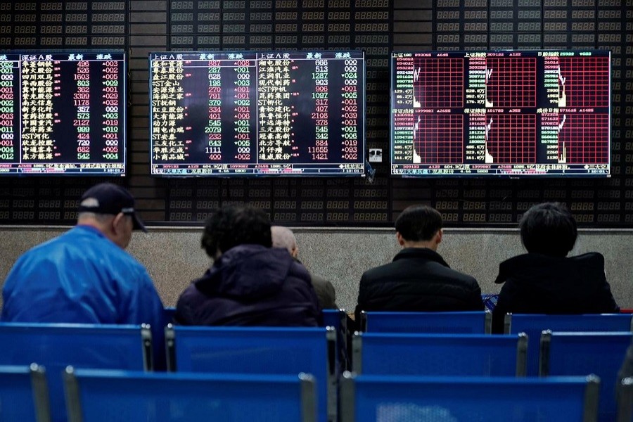 Investors look at screens showing stock information at a brokerage house in Shanghai, China January 16, 2020 — Reuters/Files