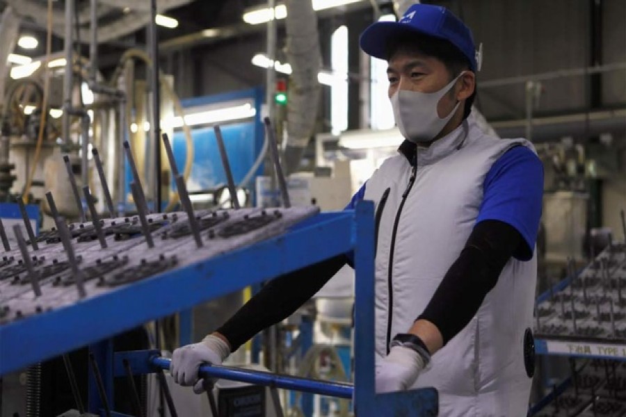 An employee of Marelli?fs factory wearing a protective face mask and a vest equipped with battery-powered fans at the waist, to prevent heatstroke during summer season, is seen amid the coronavirus disease (COVID-19) outbreak, in Ora Town, Gunma Prefecture, Japan Jul 30, 2020. REUTERS An employee of Marelli?fs factory wearing a protective face mask and a vest equipped with battery-powered fans at the waist, to prevent heatstroke during summer season, is seen amid the coronavirus disease (COVID-19) outbreak, in Ora Town, Gunma Prefecture, Japan Jul 30, 2020. REUTERS