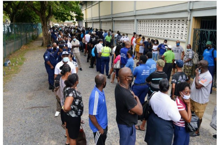 Voters queue at a polling station to cast their ballots during the presidential and parliamentary elections in Victoria, English River, Seychelles, Oct 22, 2020. REUTERS