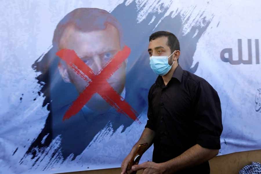 A Palestinian walking past a crossed-out picture of French President Emmanuel Macron during a protest recently –Reuters Photo