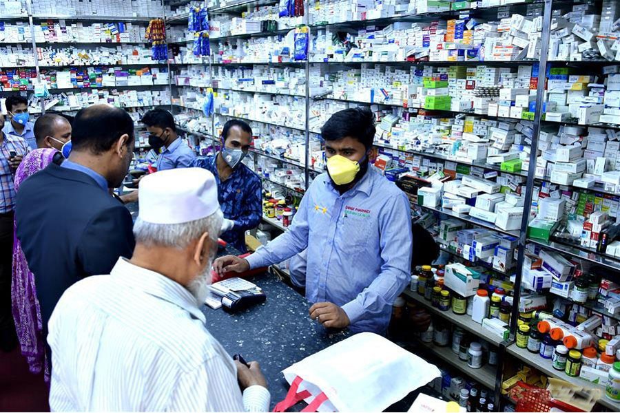 Customers buy face masks at a pharmacy in Dhaka	— Xinhua Photo