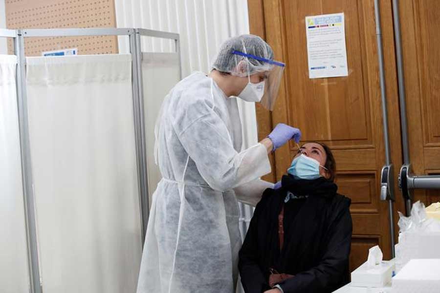 A health worker taking a swab samples from a person at a Covid-19 testing centre in Paris last month –Reuters Photo