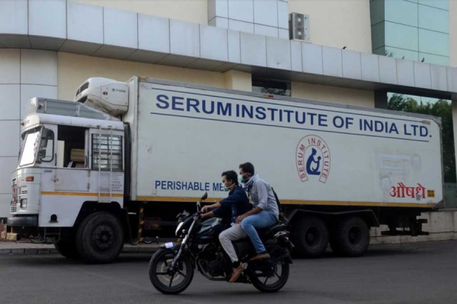 Men ride on a motorbike past a supply truck of India's Serum Institute, the world's largest maker of vaccines, which is working on a vaccine against the coronavirus disease (Covid-19) in Pune, India, May 18, 2020 — Reuters/Files