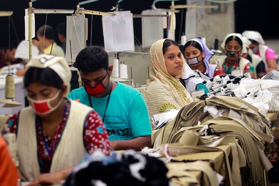 Women work at a garment factory inside the Dhaka Export Processing Zone (DEPZ) in Savar, April 11, 2013 – Reuters/Files