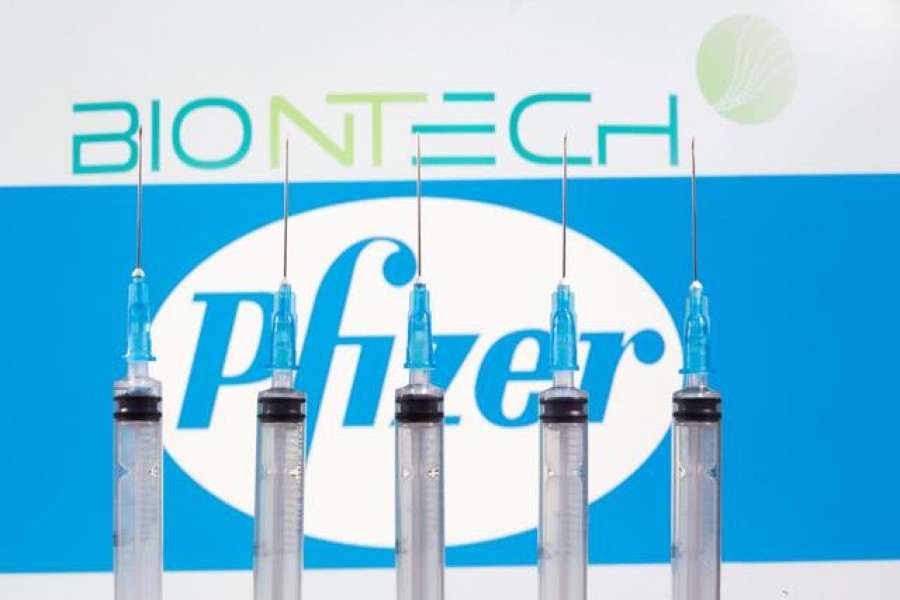 Syringes are seen in front of displayed Biontech and Pfizer logos in this illustration taken on November 10, 2020 — Reuters/Files