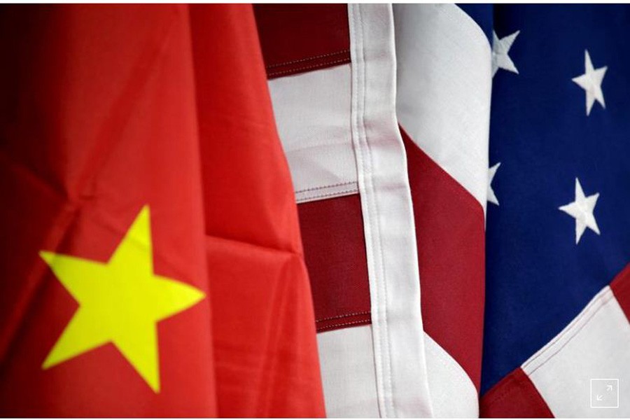 FILE PHOTO: Flags of US and China are displayed at American International Chamber of Commerce (AICC)'s booth during China International Fair for Trade in Services in Beijing, China, May 28, 2019. REUTERS/Jason Lee/File Photo