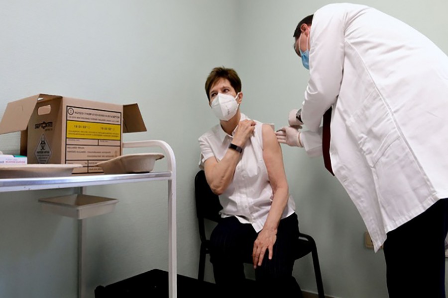Healthcare worker Adrienne Kertesz, receives the first injection nationwide, with a dose of Pfizer-BioNTech COVID-19 vaccine at the Del-Pest Central Hospital as the coronavirus disease (COVID-19) outbreak continues, in Budapest, Hungary, December 26, 2020. Szilard Koszticsak/Pool via REUTERS