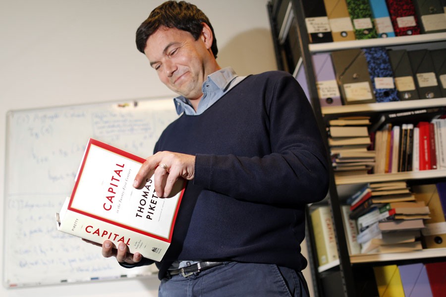 French economist and academic Thomas Piketty with his magnum opus Capital in the Twenty First Century        - Reuters