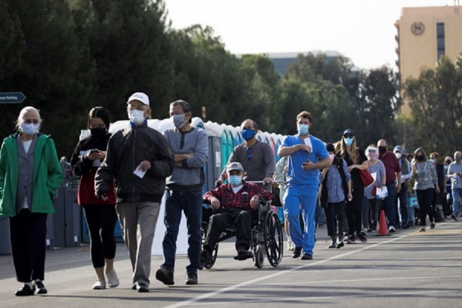 People wait in line in a Disneyland parking lot to receive a dose of the Moderna COVID-19 at a mass vaccination site during the outbreak of the coronavirus disease (COVID-19), in Anaheim, California, US, January 13, 2021. Reuters