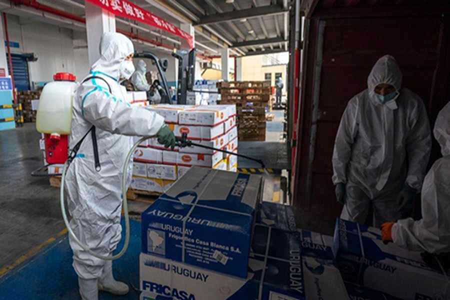 A staff member sprays disinfectant on the package of imported cold chain food at a regional cold chain centre in Wuhan, capital of central China's Hubei Province, Jan 07, 2021.Photo: Xinhua