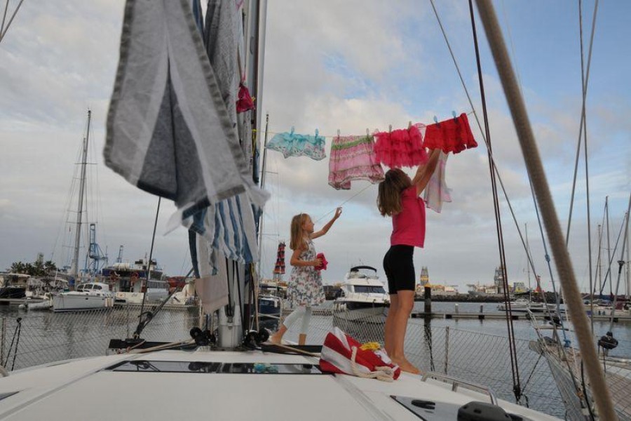 Katalin Bosze and Boroka Bosze hang clothes to dry on the sailing boat 'Teatime' in Las Palmas, Spain on October 5, 2020 — Sailingteatime via Reuters