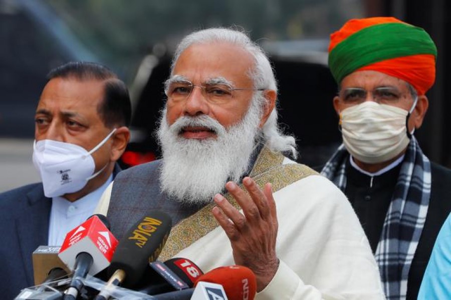 FILE PHOTO: India's Prime Minister Narendra Modi speaks with the media as he arrives at the parliament house to attend the first day of the budget session, in New Delhi, India, January 29, 2021. REUTERS/Adnan Abidi