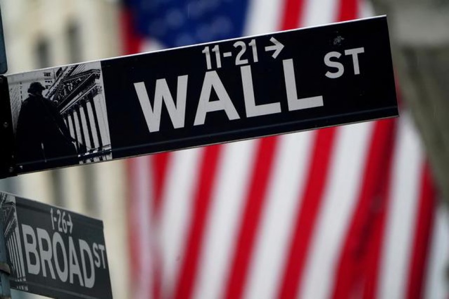 FILE PHOTO: A Wall Street sign outside the New York Stock Exchange in New York City, New York, US, October 2, 2020. REUTERS/Carlo Allegri