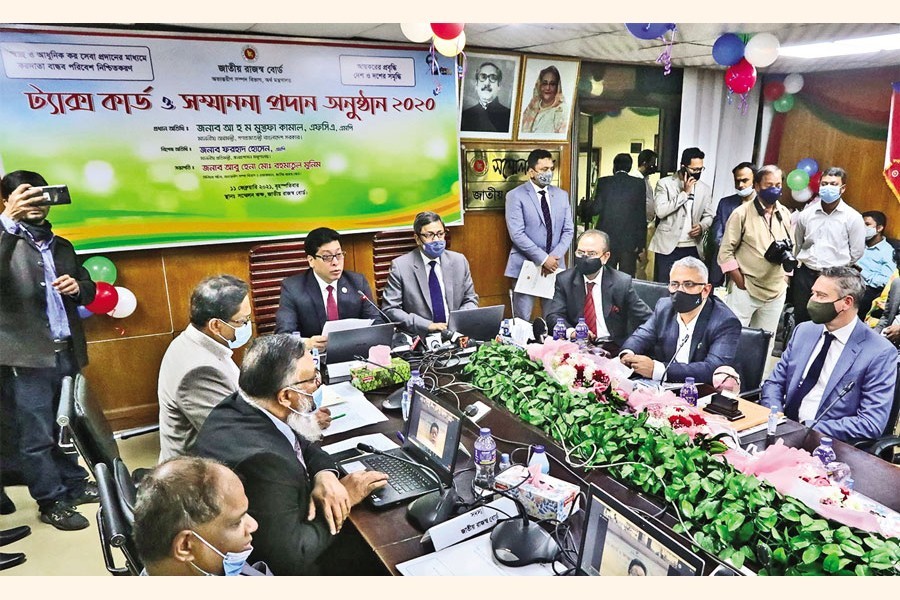 State Minister for Public Administration Farhad Hossain speaking at a ceremony organised to honour the taxpayers with tax cards at the conference room of the National Board of Revenue (NBR) in the city on Thursday — FE Photo