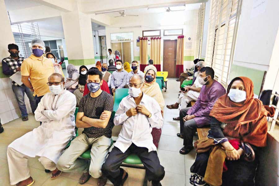 People wait at the city’s Mugda Medical College and Hospital on Saturday for taking Covid-19 vaccines as the government’s inoculation drive continues across the country — FE photo by KAZ Sumon