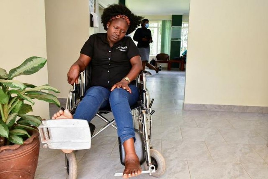 Irene Abalo, a journalist working with The Daily Monitor newspaper, sits on a wheelchair after she was injured following an attack by security officials, outside the United Nations Human Rights offices while on reporting duty, in Kampala, Uganda February 17, 2021. REUTERS/Abubaker Lubowa