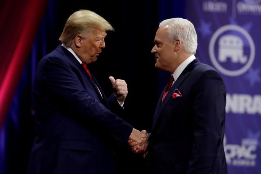 Former US President Donald Trump (L) shakes hands with Matt Schlapp, chairman of the American Conservative Union, at the Conservative Political Action Conference (CPAC) annual meeting at National Harbor in Oxon Hill, Maryland, US, February 29, 2020. REUTERS/Yuri Gripas/File Photo