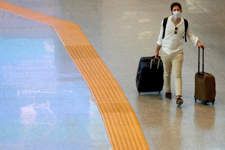 A passenger wearing a protective face mask walks at Fiumicino Airport in Rome, Italy on May 28, 2020 — Reuters/Files
