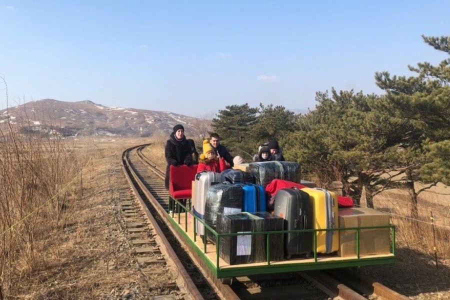 image captionThe group of Russian diplomats, which included children, pushed themselves for more than 1km over train tracks - Photo courtesy: Russian Foreign Ministry/Facebook