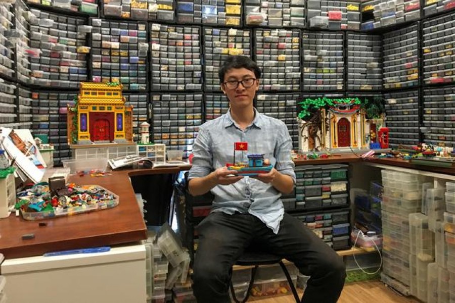 Hoang Dang, an industrial designer who loves Lego since he was a child poses in front of his pieces at his home in Hanoi, Vietnam March 13, 2021. REUTERS/Minh Nguyen
