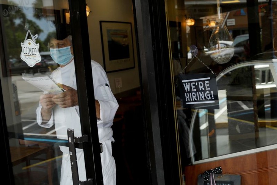 A "We're Hiring" sign advertising jobs is seen at the entrance of a restaurant, as Miami-Dade County eases some of the lockdown measures put in place during the coronavirus disease (Covid-19) outbreak, in Miami, Florida, US on May 18, 2020 — Reuters/Files