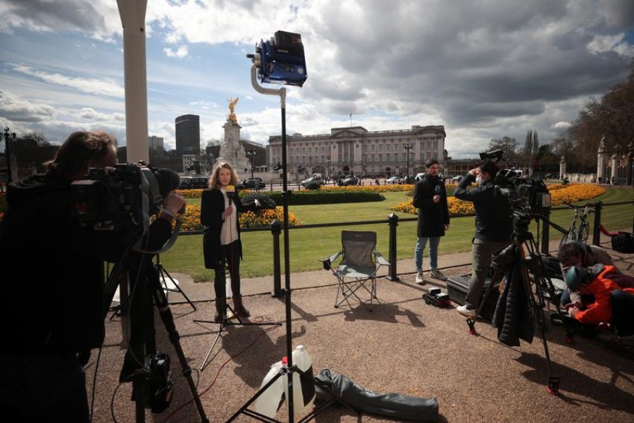 Members of the media report outside Buckingham Palace after it was announced that Britain's Prince Philip, husband of Queen Elizabeth, has died at the age of 99, in London, Britain, April 9, 2021 — Reuters