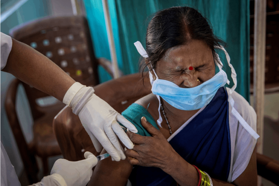 A healthcare worker reacts as she receives a dose of COVISHIELD, a COVID-19 vaccine manufactured by Serum Institute of India, during one of the world's largest COVID-19 vaccination campaigns at Mathalput Community Health Centre in Koraput district of the eastern state of Odisha, India, January 16, 2021. REUTERS/Danish Siddiqui