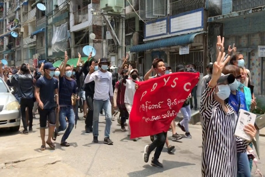Demonstrators flash three-finger salute during a protest in Sanchaung, Yangon, Myanmar April 27, 2021 in this still image obtained from a social media video. Courtesy of NEWS AMBASSADOR/via REUTERS
