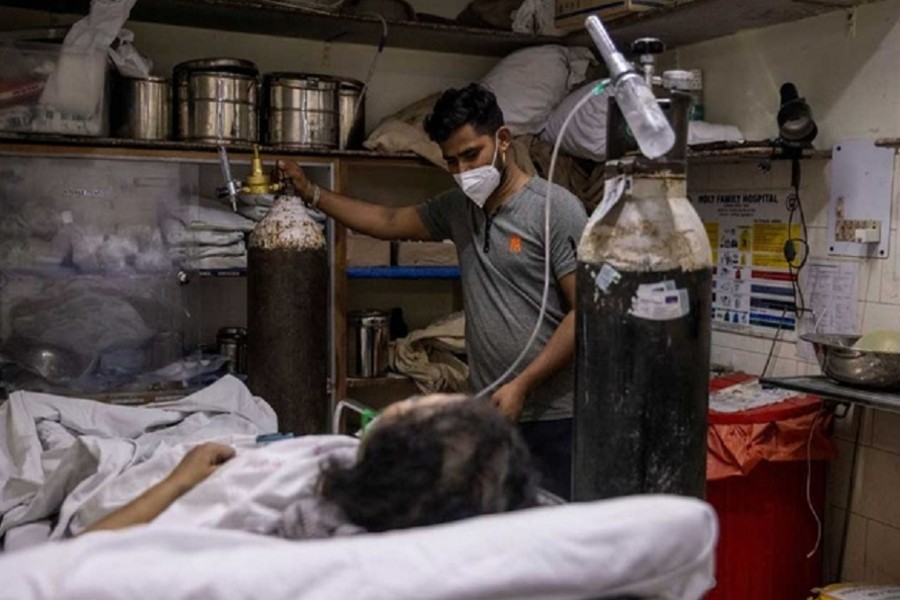 A woman suffering from the coronavirus disease (COVID-19) is treated inside an overcrowded casualty ward at a hospital in New Delhi, India, May 1, 2021. REUTERS
