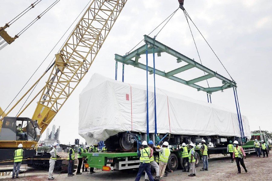 One of the Metro Rail coaches is being lifted into a lorry with the help of a crane for transportation to Dhaka Mass Transit Company's depot at Diabari in Uttara, Dhaka on April 22, 2021 — Focus Bangla/Files