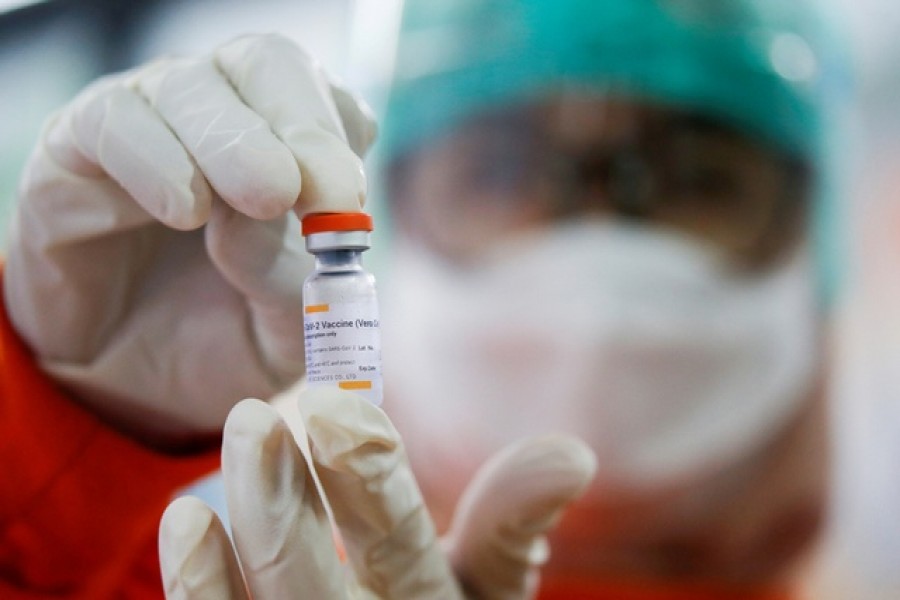 A medical worker holds a dose of the Sinovac vaccine at a district health facility as Indonesia begins mass vaccination for the coronavirus disease (COVID-19), starting with its healthcare workers, in Jakarta, Indonesia Jan 14, 2021. REUTERS