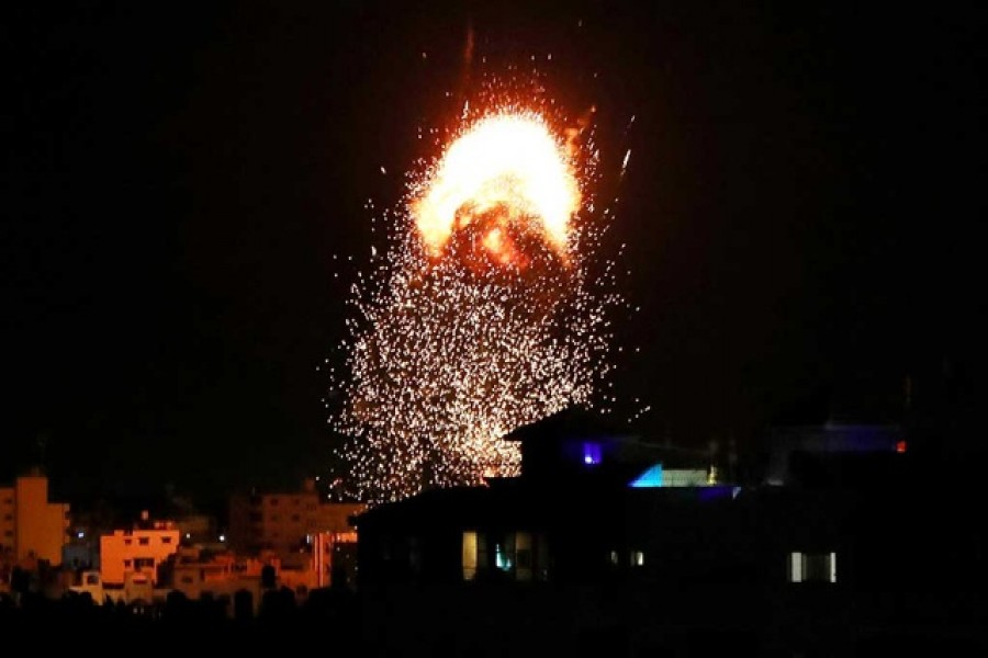 Smoke and flames rise above a building during Israeli air strikes, amid a flare-up of Israeli-Palestinian fighting, in Gaza City May 17, 2021. REUTERS