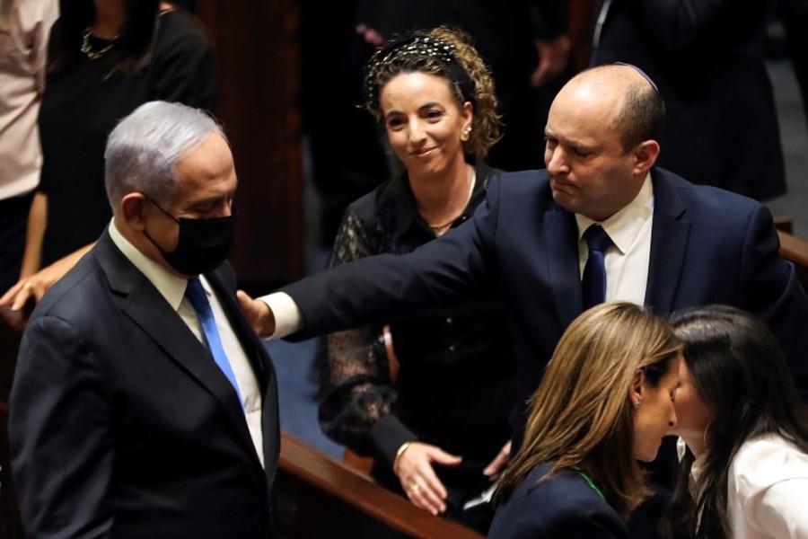 Head of Oposition Benjamin Netanyahu and Israel Prime Minister Naftali Bennett gesture following the vote on the new coalition at the Knesset, Israel's parliament, in Jerusalem on June 13, 2021 — Reuters photo