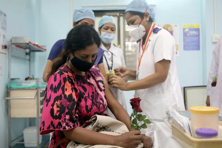A healthcare worker holding a rose receives an AstraZeneca's COVISHIELD vaccine, during the coronavirus disease (COVID-19) vaccination campaign, at a medical centre in Mumbai, India, January 16, 2021. REUTERS