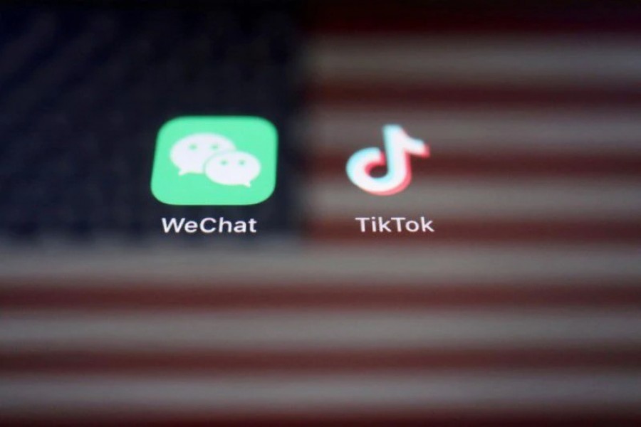 A reflection of the US flag is seen on the signs of the WeChat and TikTok apps in this illustration picture taken on September 19, 2020 — Reuters/Files