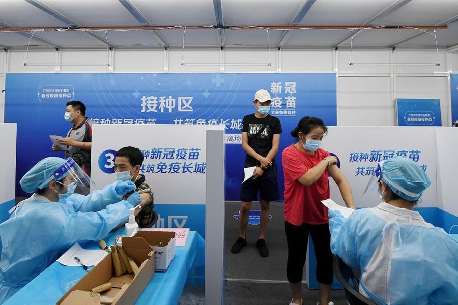 Residents receive vaccines against the coronavirus disease (Covid-19) at a makeshift vaccination site in Guangzhou, Guangdong province, China on June 21, 2021 — cnsphoto via REUTERS