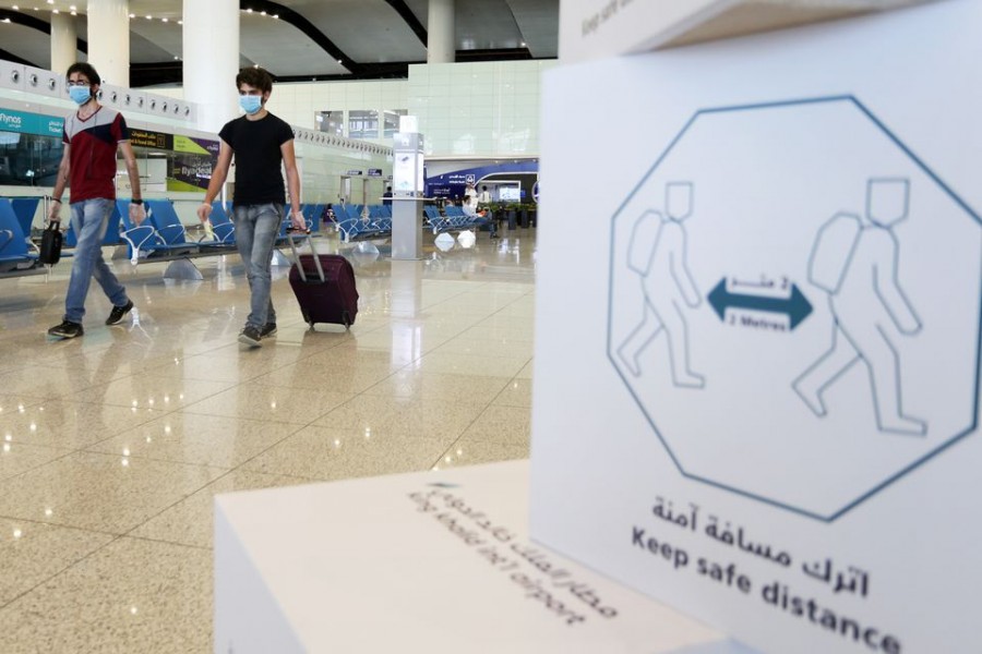 Travellers wearing protective face masks walk at Riyadh International Airport, after Saudi Arabia reopened domestic flights, following the outbreak of the coronavirus disease (COVID-19), in Riyadh, Saudi Arabia May 31, 2020. REUTERS/Ahmed Yosri