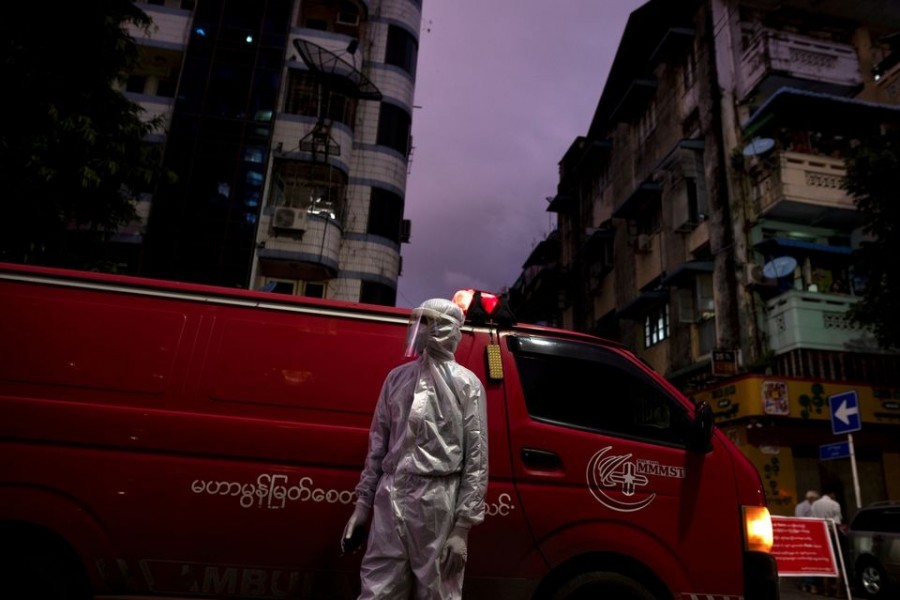 A medical staff wearing a protective suit stands near an ambulance, amid the outbreak of the coronavirus disease (Covid-19), in Yangon, Myanmar on September 27, 2020