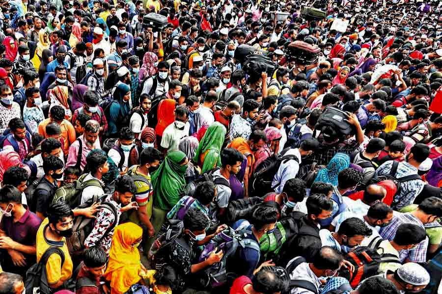 People, mostly factory workers, packed like sardines in a ferry arrive at Shimulia ferry terminal in Munshiganj on Saturday on their way to Dhaka following the government's sudden announcement about reopening of factories amidst the ongoing lockdown —FE photo