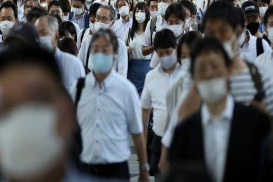 Commuters wearing face masks arrive at Shinagawa Station at the start of the working day amid the coronavirus disease (COVID-19) outbreak, in Tokyo, Japan, August 2, 2021. Reuters/ Kevin Coombs