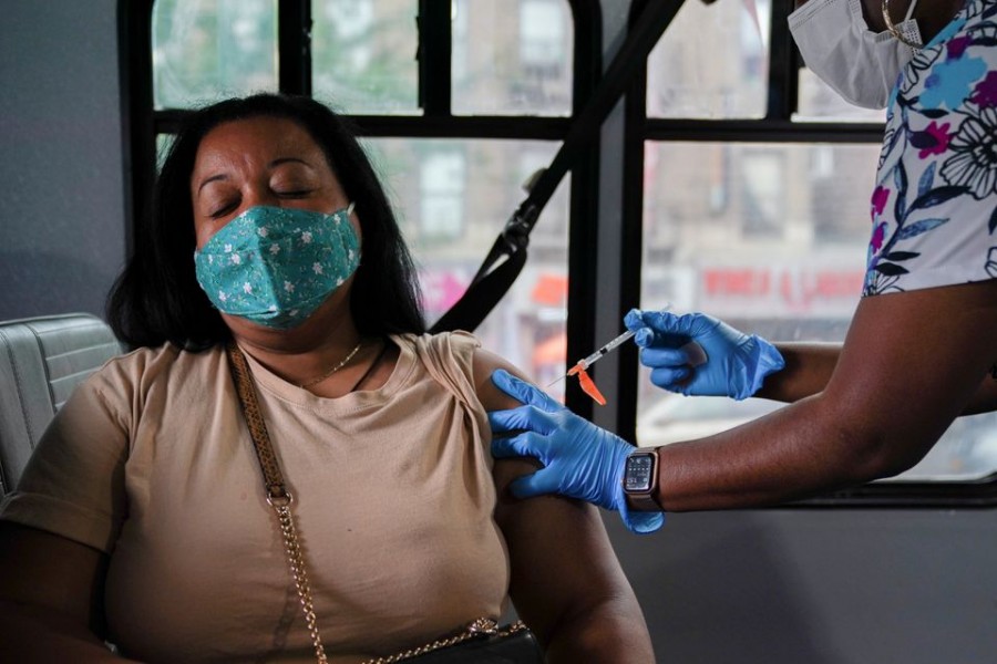 A person receives a dose of the Pfizer-BioNTech vaccine for the coronavirus disease (COVID-19), at a mobile inoculation site in the Bronx borough of New York City, New York, US, August 18, 2021. REUTERS/David 'Dee' Delgado/File Photo