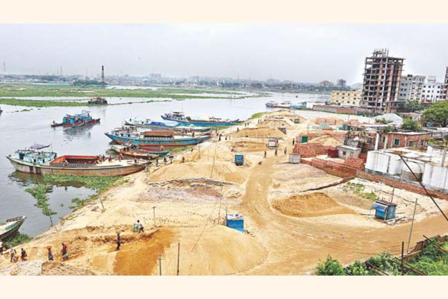 Sand traders filling a part of Turag river in Dhaka