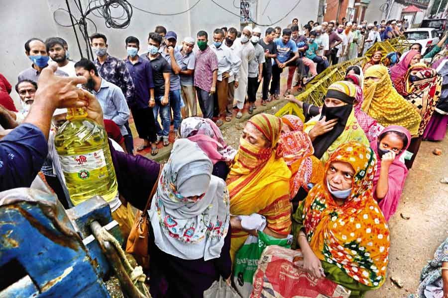 People waiting in queues to buy daily commodities at a TCB sales point near the National Press Club in the city on June 17 this year –FE file photo