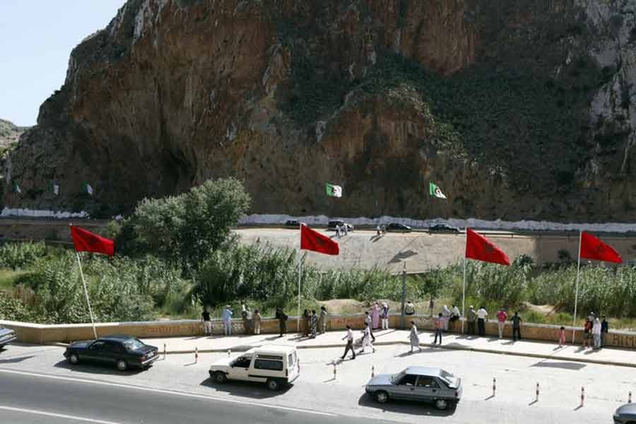 People standing near a border post on the Algerian side of the Morocco-Algeria border in the north east of Morocco –Reuters file photo