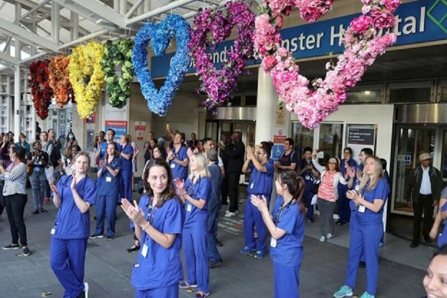 NHS workers and members of the public react at the Chelsea and Westminster Hospital during the last day of the Clap for our Carers campaign in support of the NHS, following the outbreak of the coronavirus disease (COVID-19), London, Britain, May 28, 2020. Reuters