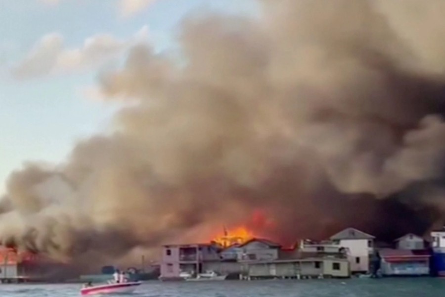 Smoke billows from a fire at a residential area on the island of Guanaja, Honduras in this screen grab taken from a video taken October 2, 2021. COPECO/Reuters TV via REUTERS
