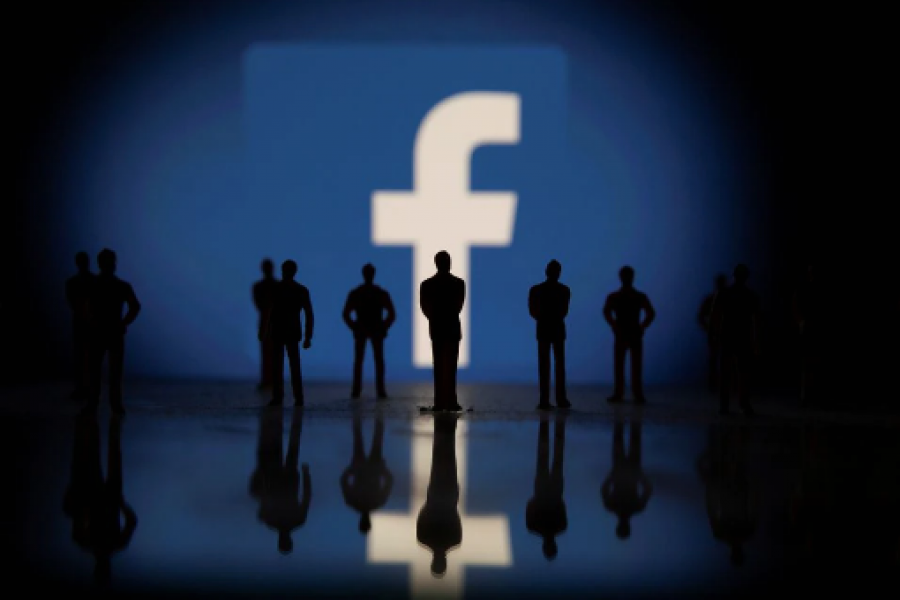 Small toy figures are seen in front of displayed Facebook logo in this illustration taken October 4, 2021. REUTERS/Dado Ruvic/Illustration