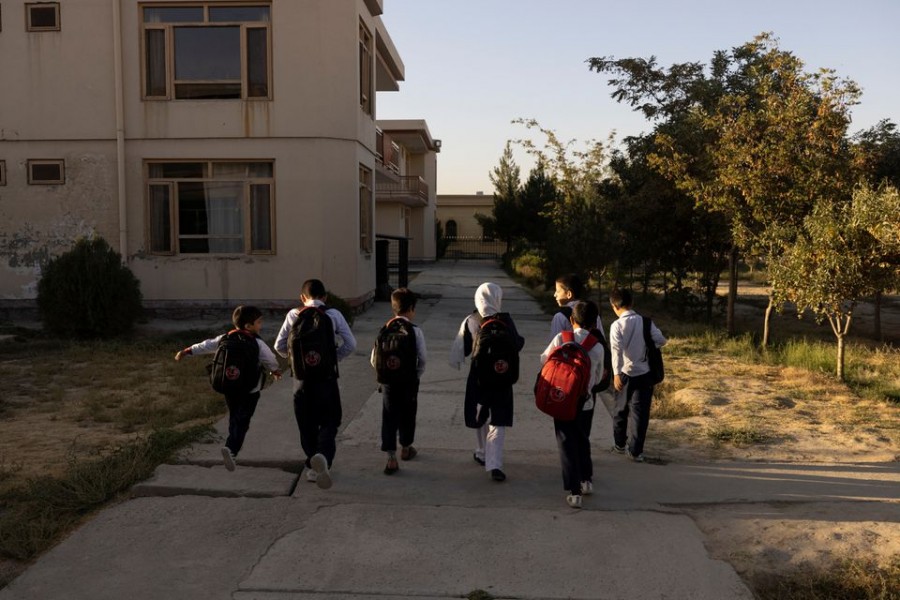 Samira, 9, and other children from the orphanage walk to the school bus in Kabul, Afghanistan on October 12, 2021 — Reuters photo