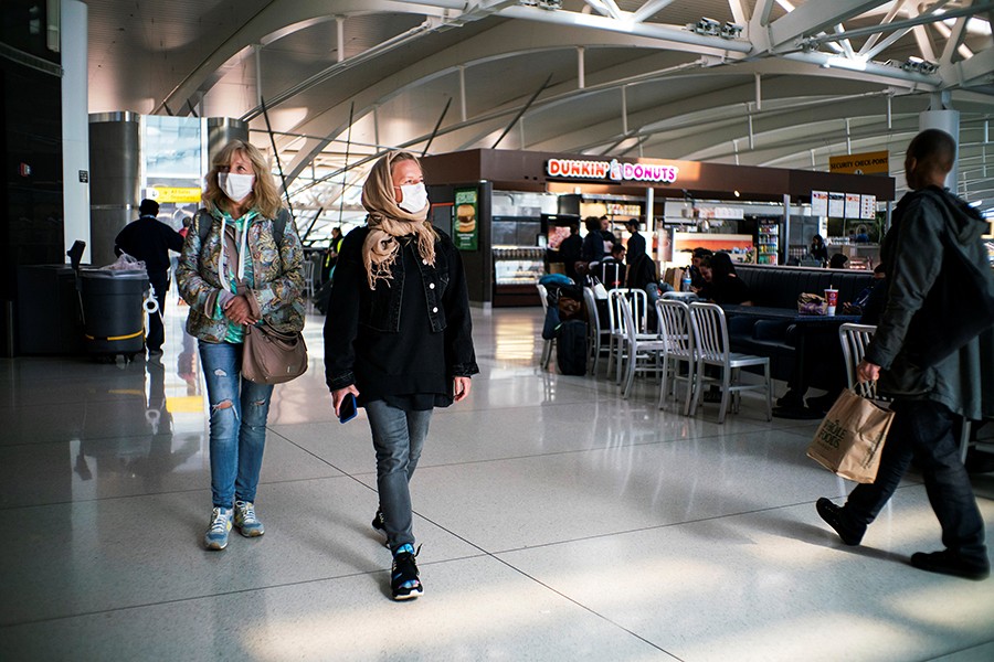 People walk around terminal one at JFK airport after the Federal Aviation Administration (FAA) temporarily halted flights arriving at New York City airports due to coronavirus disease (Covid-19) in New York, US on March 21, 2020 — Reuters/Files