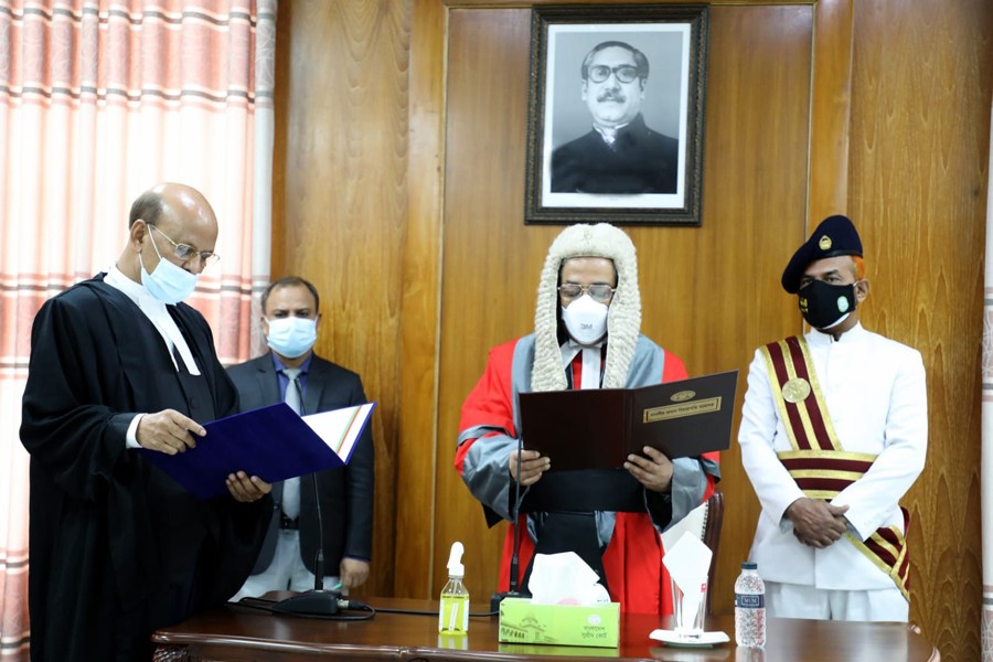 Chief Justice Syed Mahmud Hossain administers the oath of office to nine additional judges in a swearing-in ceremony